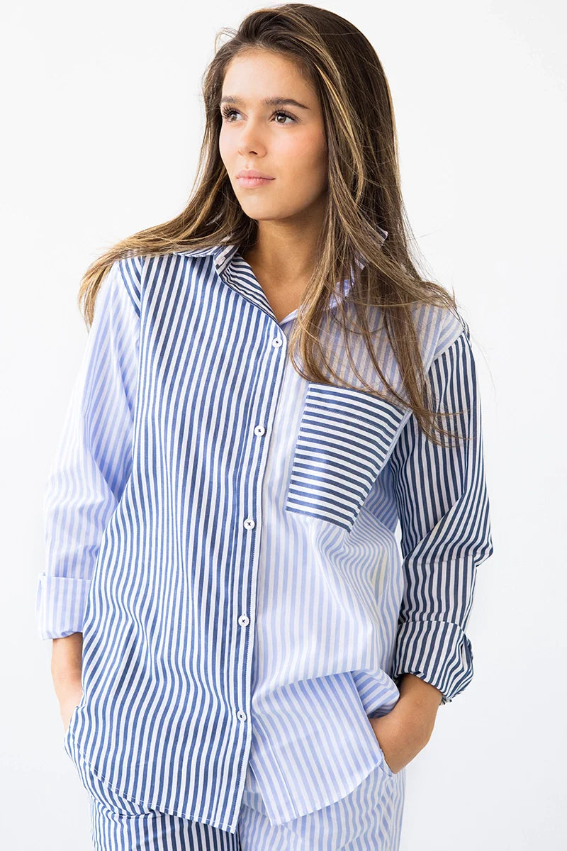 Woman wearing a blue and white striped shirt against a white background