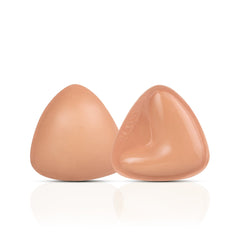 Two silicone breast forms on a white background