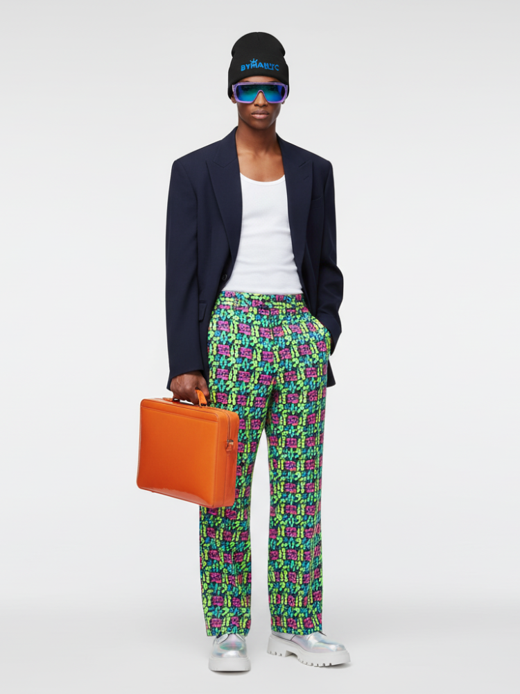 Person wearing a navy blazer, white shirt, colorful pants, and holding an orange briefcase on a white background