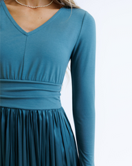 Teal long-sleeve dress on a white background