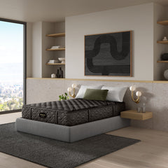 Gray mattress on a bed in a modern bedroom with shelves and artwork.