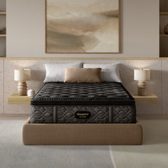 Gray mattress on a bed in a modern bedroom setting with lamps and artwork.