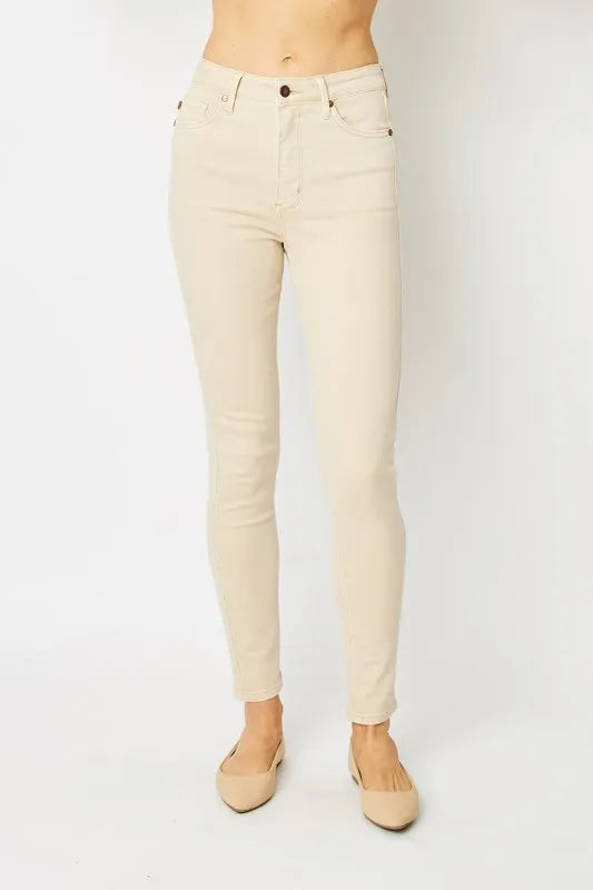 Beige jeans worn by a person on a white background