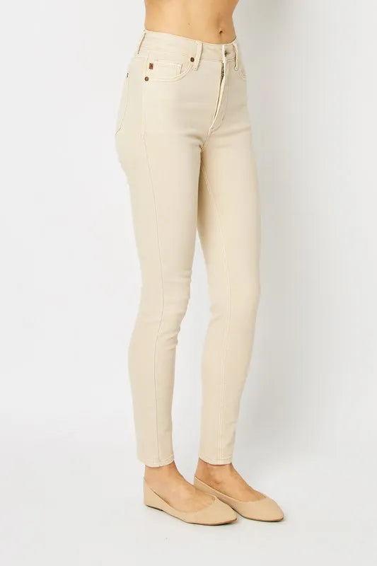 Beige jeans worn by a person on a white background