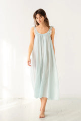 Woman wearing a light blue dress on a white background