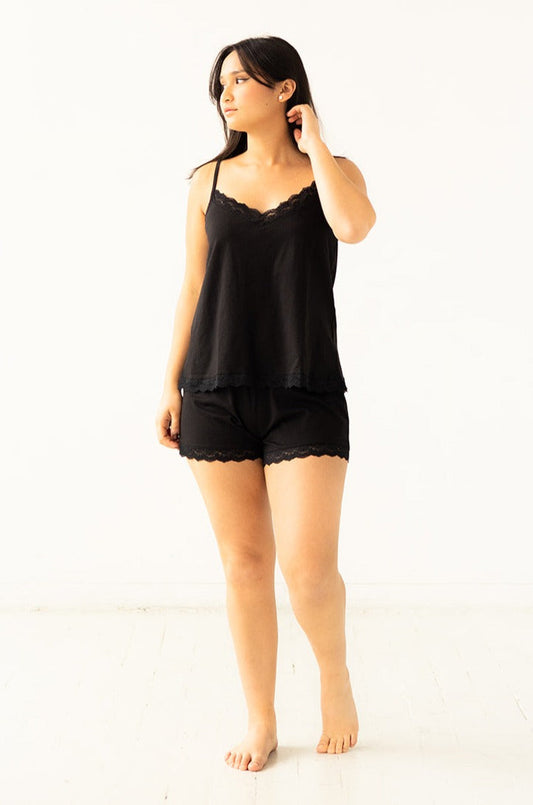 Woman wearing a black lace nightgown on a white background