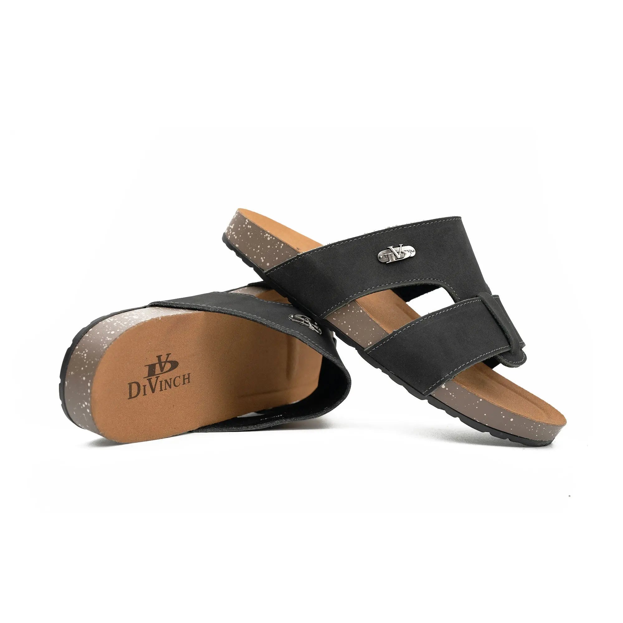 Black sandals with brown soles on a white background