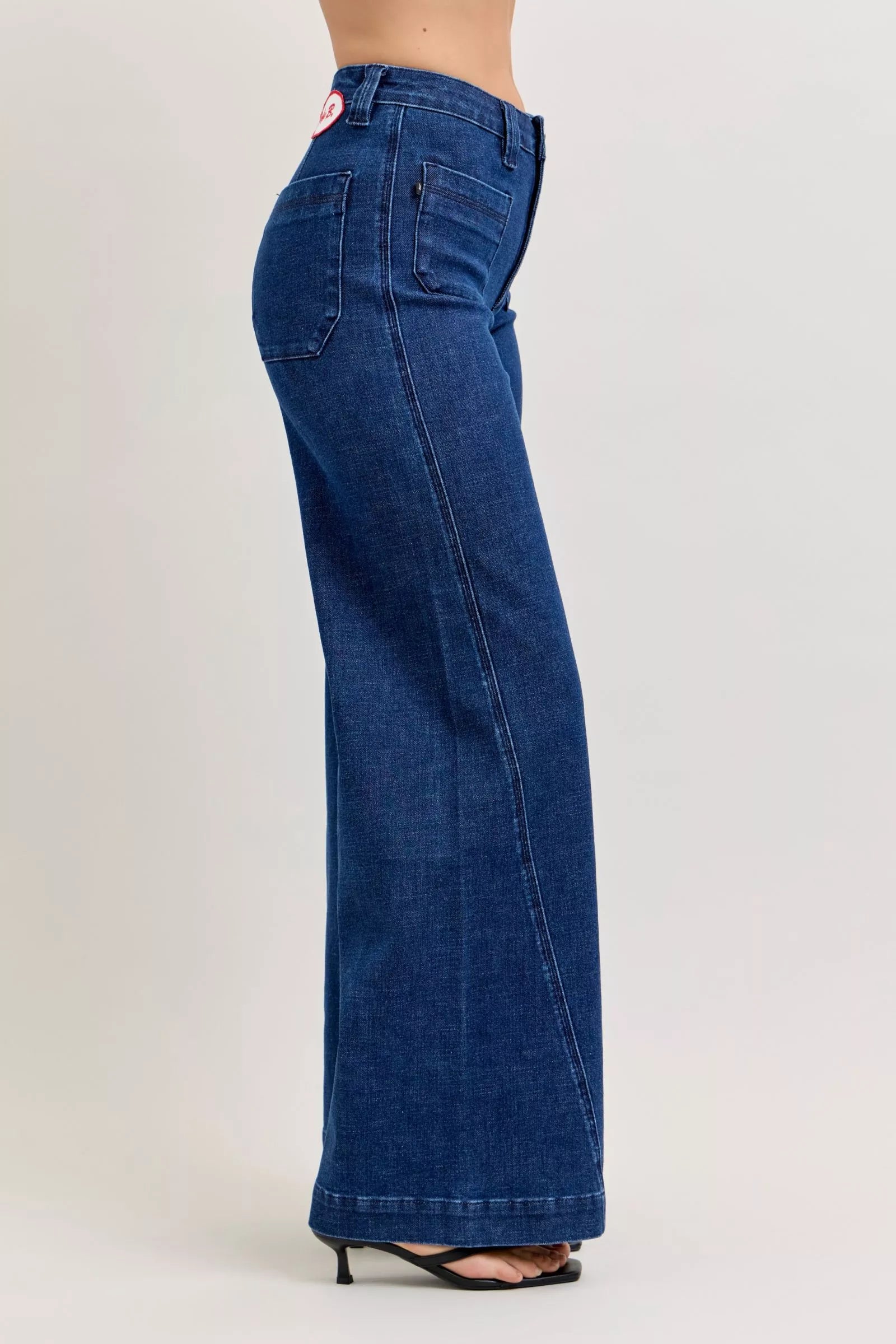 Blue jeans worn by a person on a light gray background