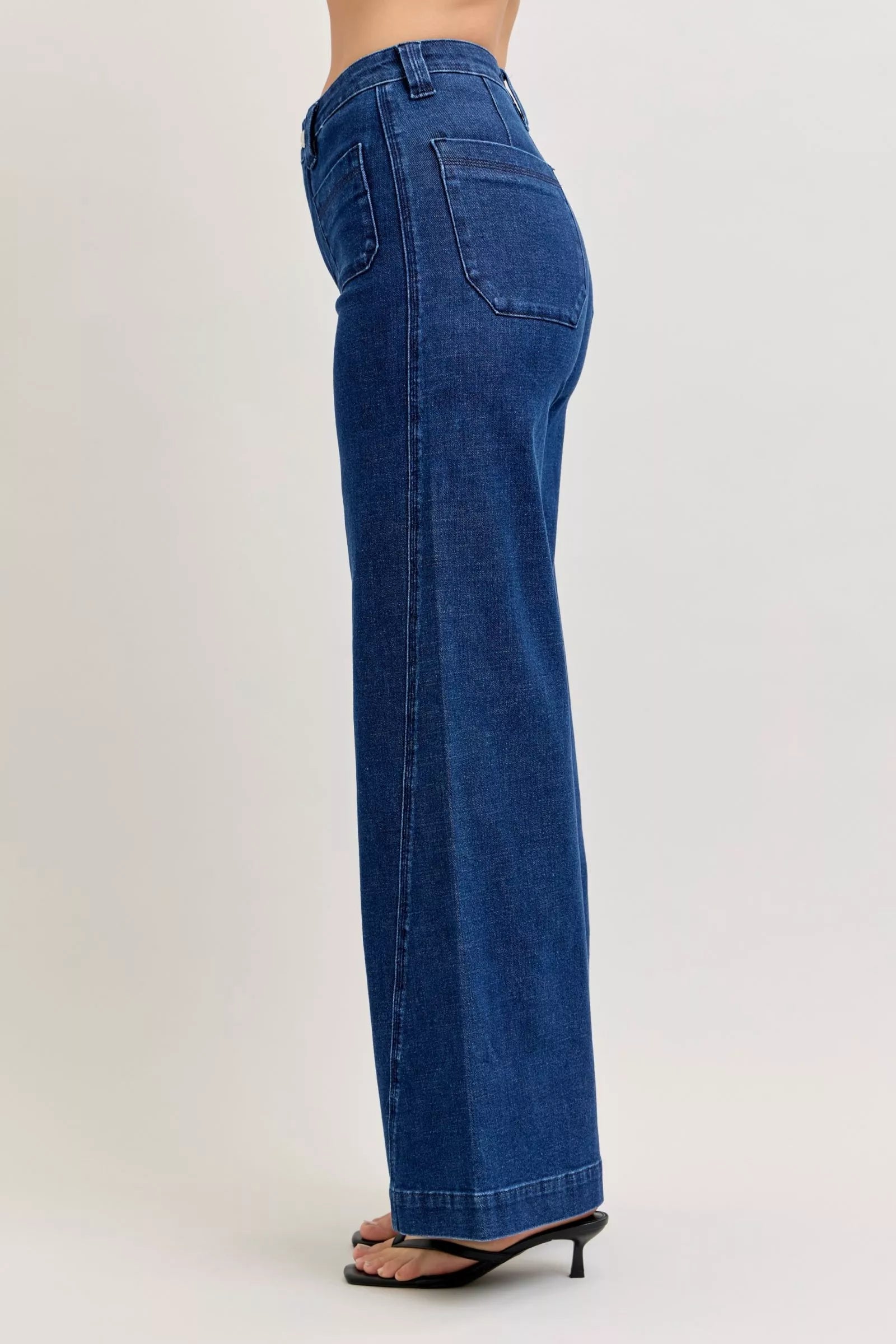 Blue jeans worn by a person on a white background