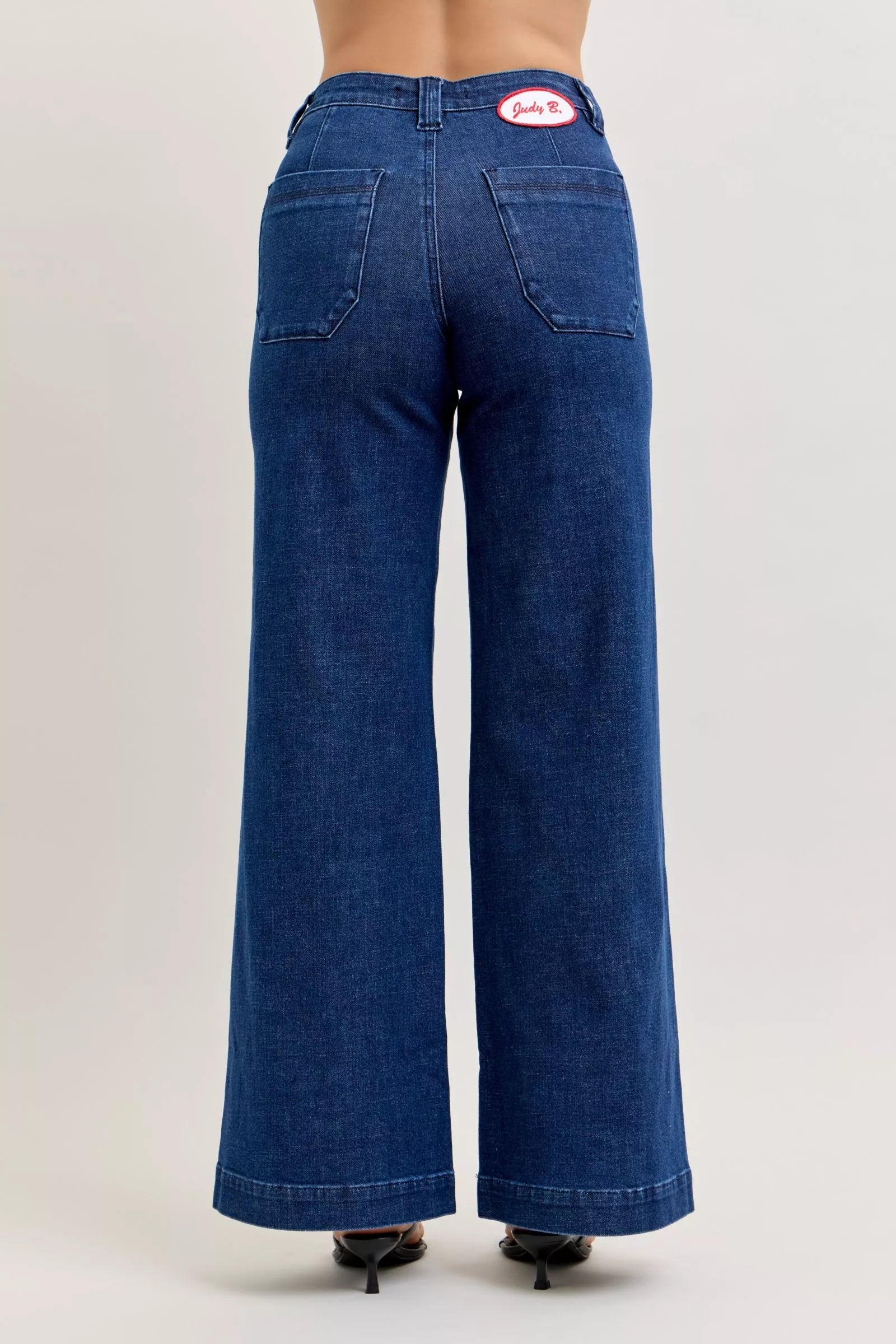 Blue jeans with a visible brand logo on a plain background