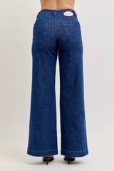 Blue jeans with a visible brand logo on a plain background