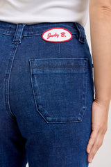Blue jeans with a patch on the back pocket, featuring the brand 'Judy B.'