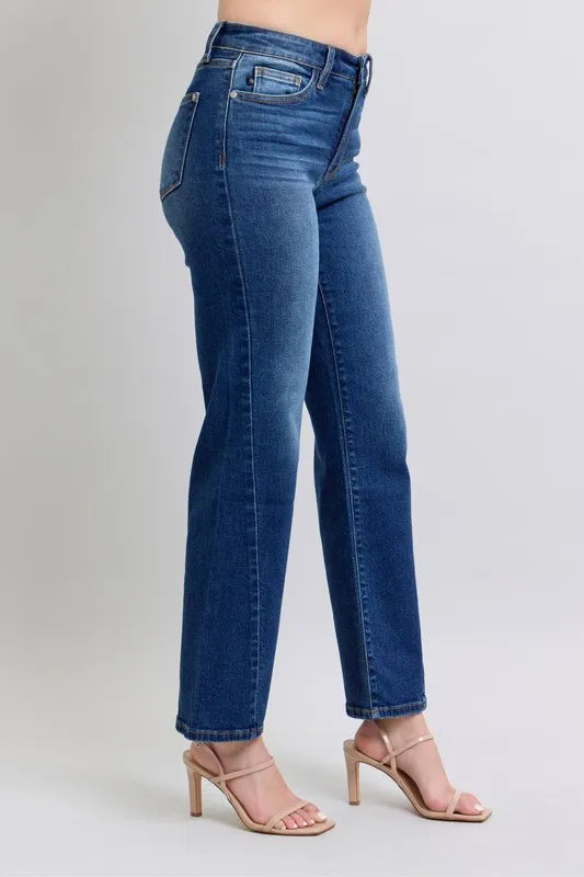 Blue jeans worn by a person on a light gray background