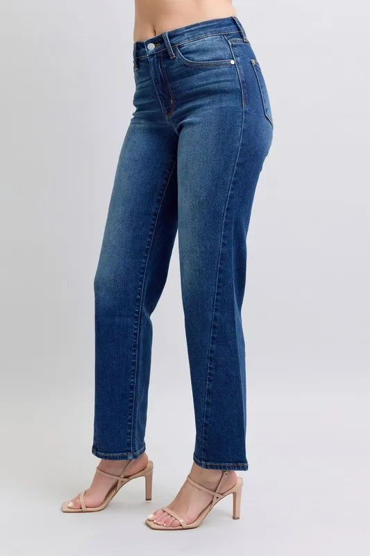 Blue jeans worn by a person on a light gray background