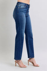 Blue jeans worn by a person on a light gray background