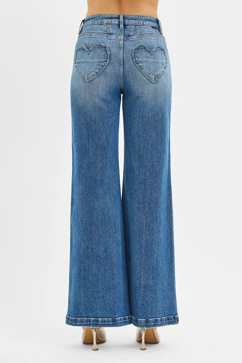 Blue jeans with heart cutouts on a white background