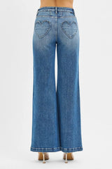 Blue jeans with heart cutouts on a white background