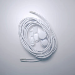 White earbuds and charging cable coiled on a light gray background