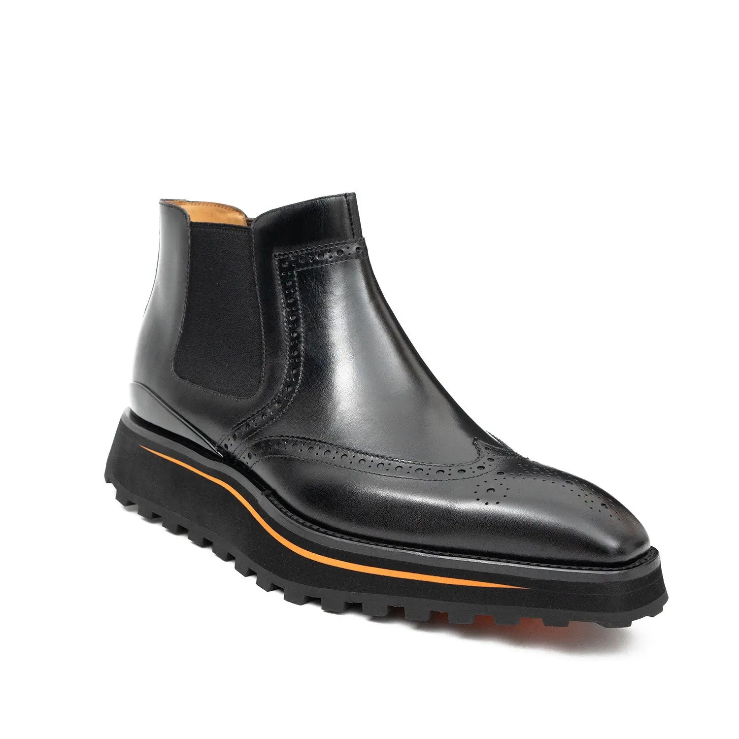 Black leather Chelsea boot with orange sole on a white background