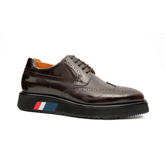 Brown leather shoe with a black sole on a white background