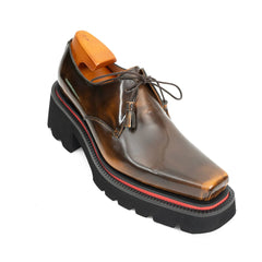 Brown leather shoe with thick black sole on a white background