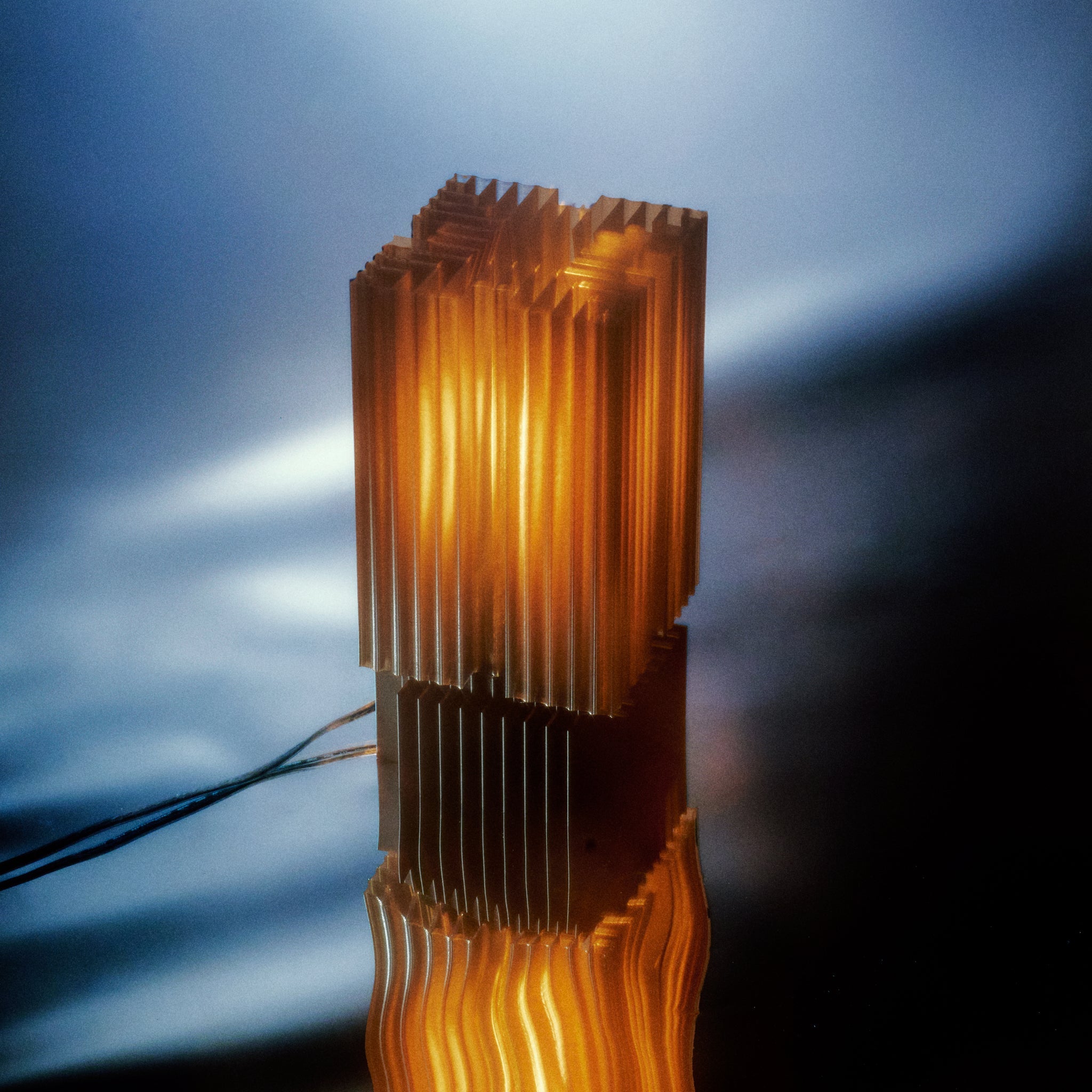 Metallic cylindrical object with a textured surface on a reflective surface