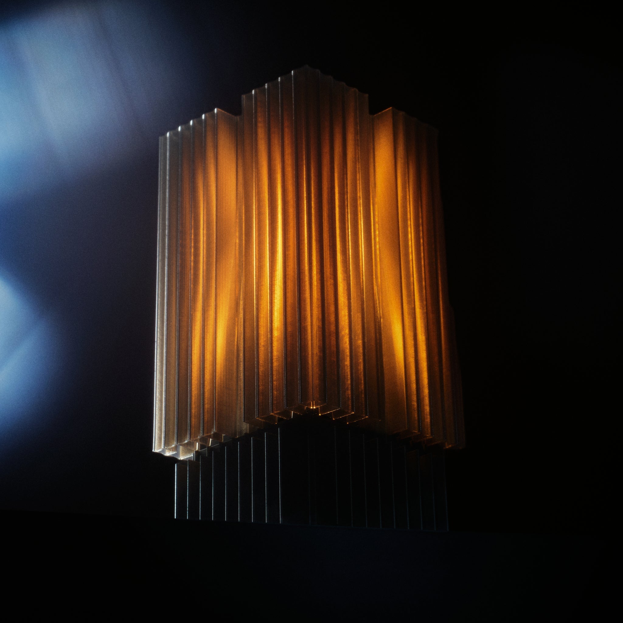 Decorative lamp with ribbed design on a dark background