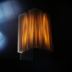 Decorative lamp with ribbed design on a dark background