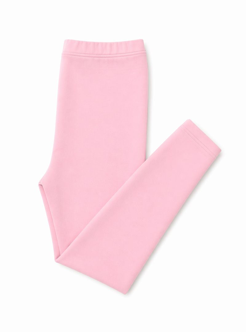 A pair of folded light pink leggings on a clean white background.