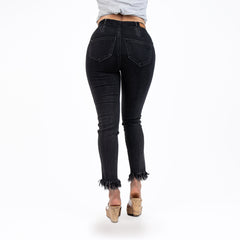 Person wearing black jeans on a white background