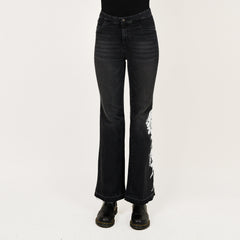 Black distressed jeans on a white background