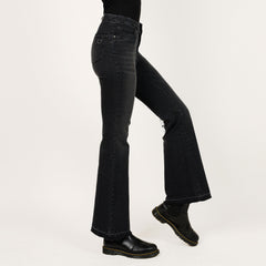 Black flared jeans worn by a person on a white background