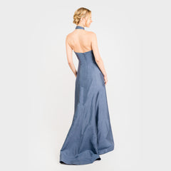Woman wearing a strapless blue gown on a white background