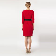 Red dress with a black belt worn by a model on a white background