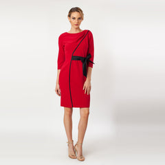 Red dress with a black belt worn by a model on a white background
