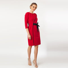 Woman wearing a red dress with a black belt on a white background