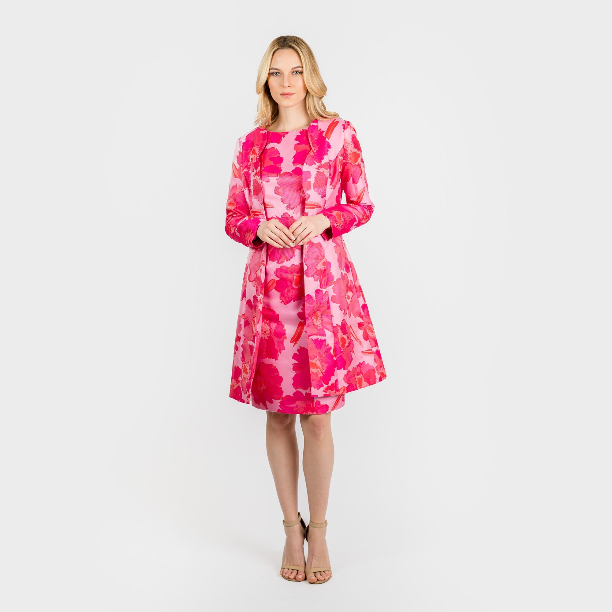Woman wearing a pink floral dress on a white background