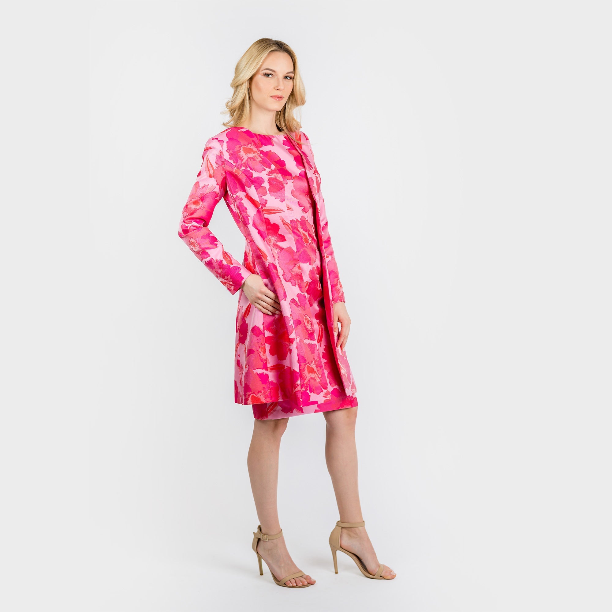 Woman wearing a pink tie-dye dress on a white background