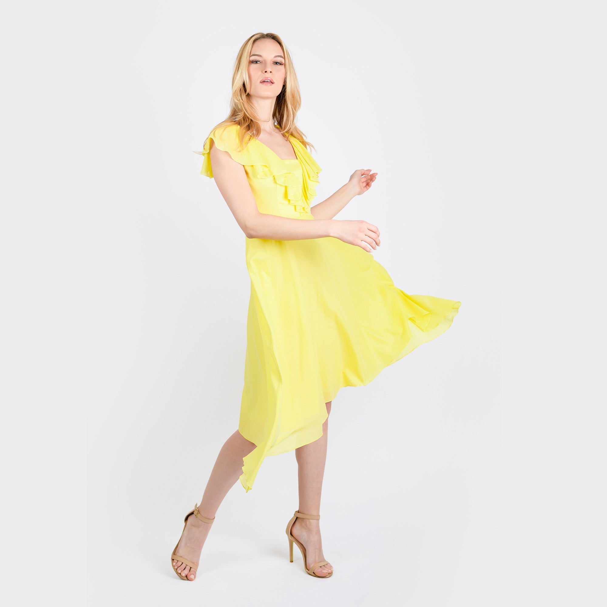 Woman wearing a yellow dress on a white background