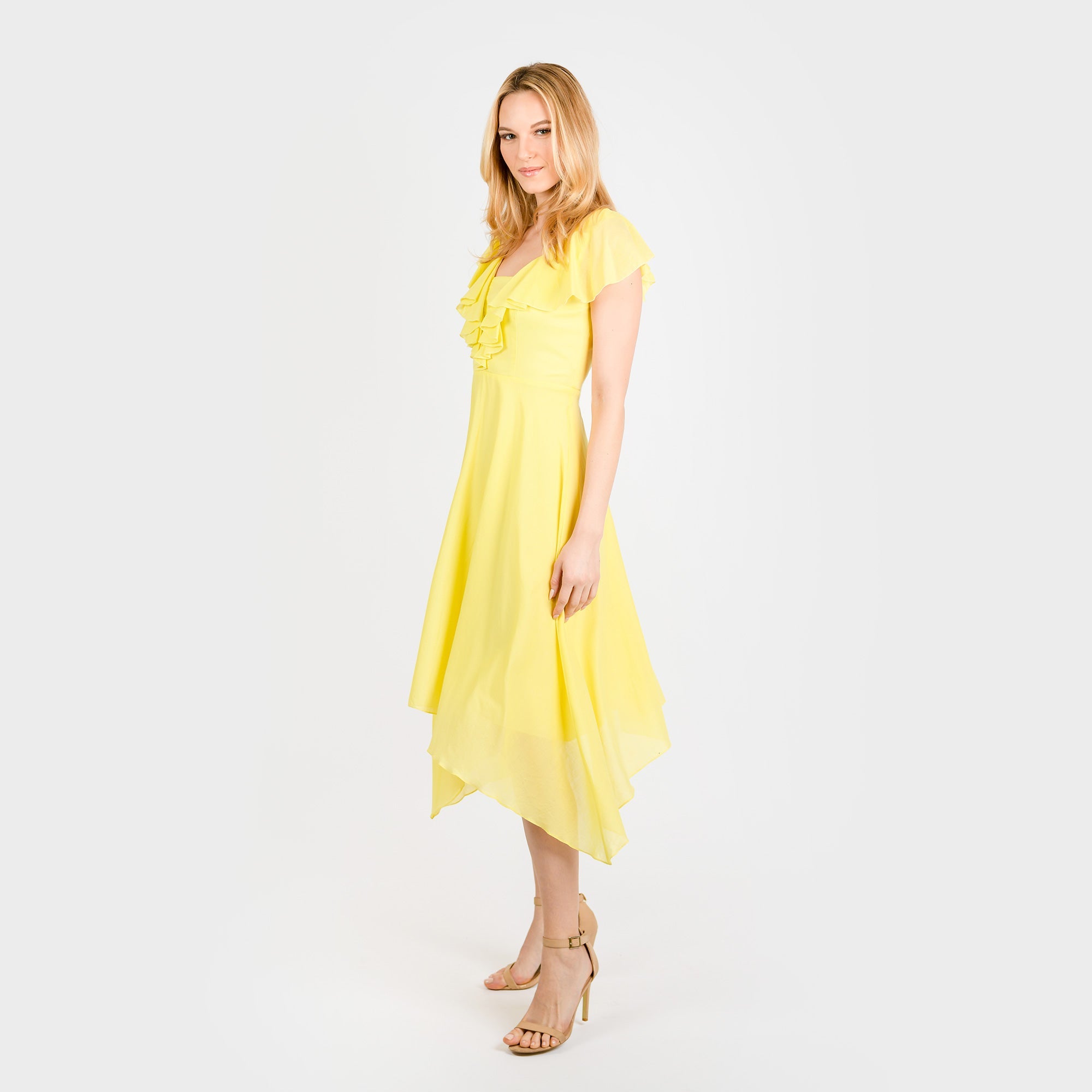 Woman wearing a yellow dress on a white background