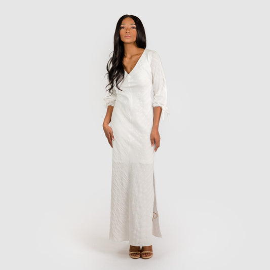 Woman wearing a long white dress on a white background