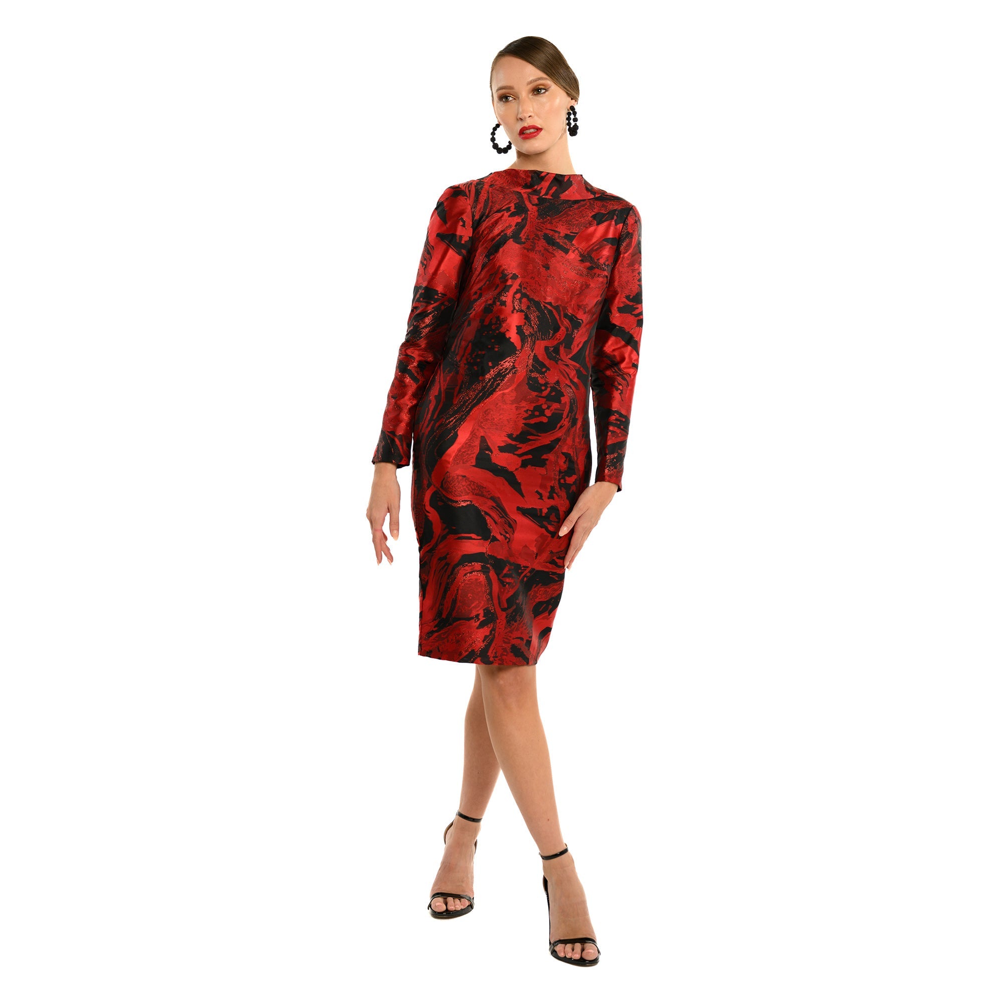 Red and black patterned dress worn by a model on a white background
