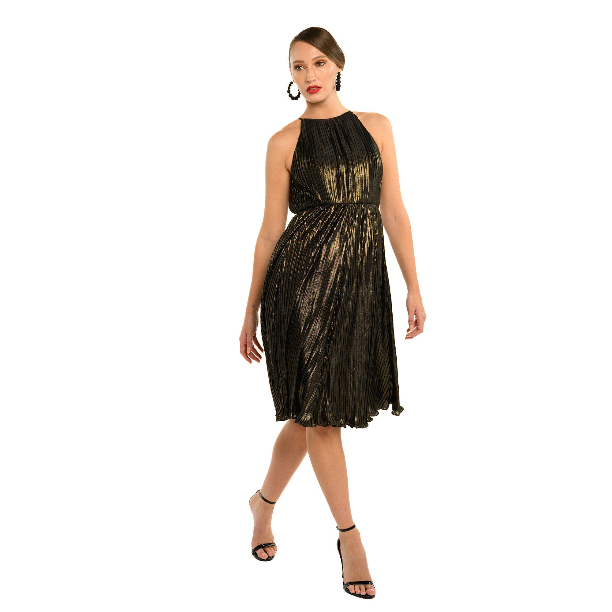 Woman wearing a black and gold dress on a white background