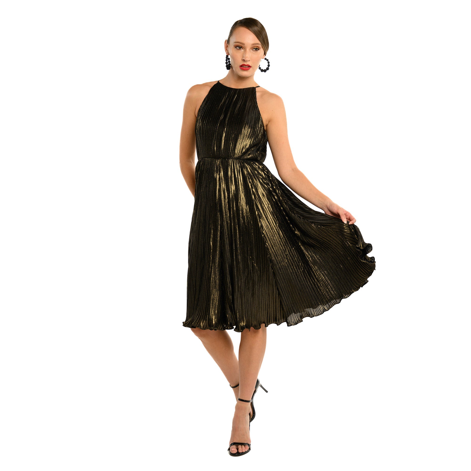 Woman wearing a black and gold dress on a white background
