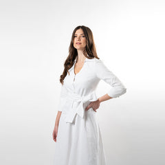 Woman wearing a white dress with a belt on a white background