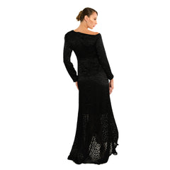 Woman wearing a black long-sleeve evening gown on a white background