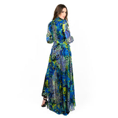 Woman wearing a long, patterned dress on a white background