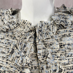 Close-up of a textured fabric with a pattern on a mannequin.