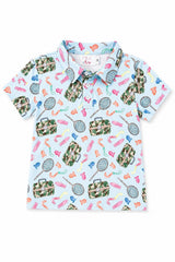 A short-sleeve polo shirt for kids on a white background, featuring a light blue base with a colorful pattern of tennis rackets, bags, and athletic shoes in green camouflage and bright colors.