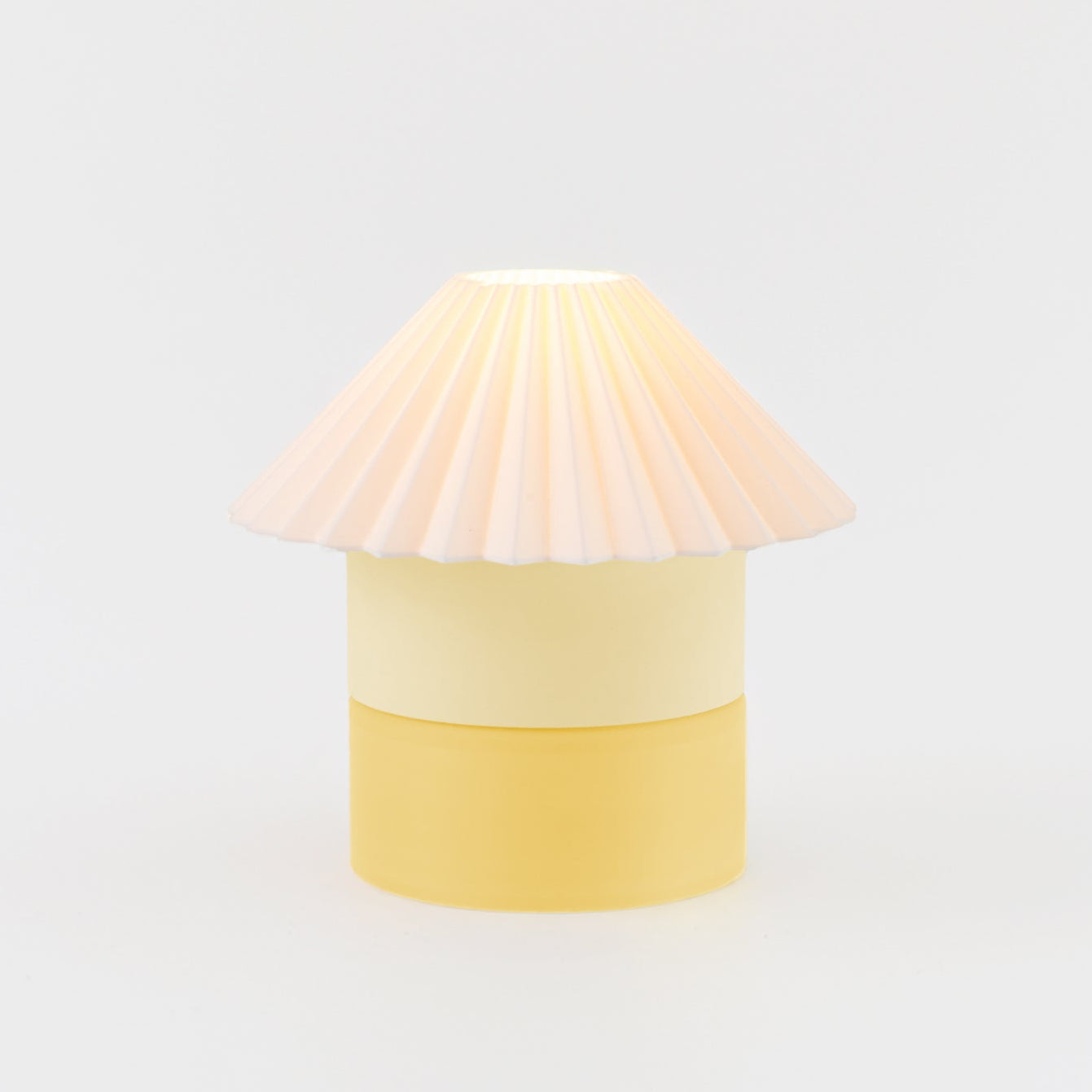 Yellow lamp with a unique shade on a light gray background